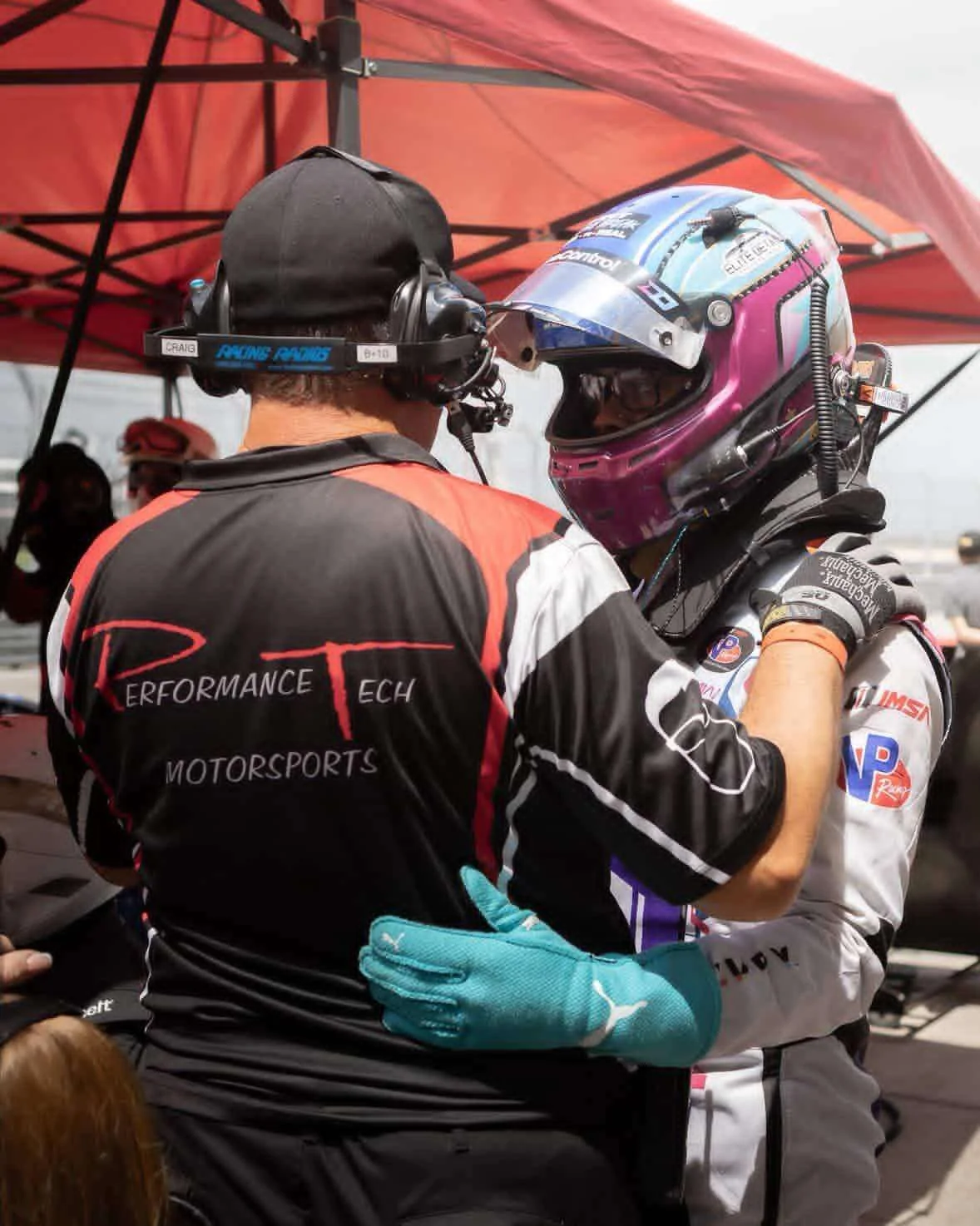 Daniel Oliver, helmet on, working through the plan with a Performance Tech crew member