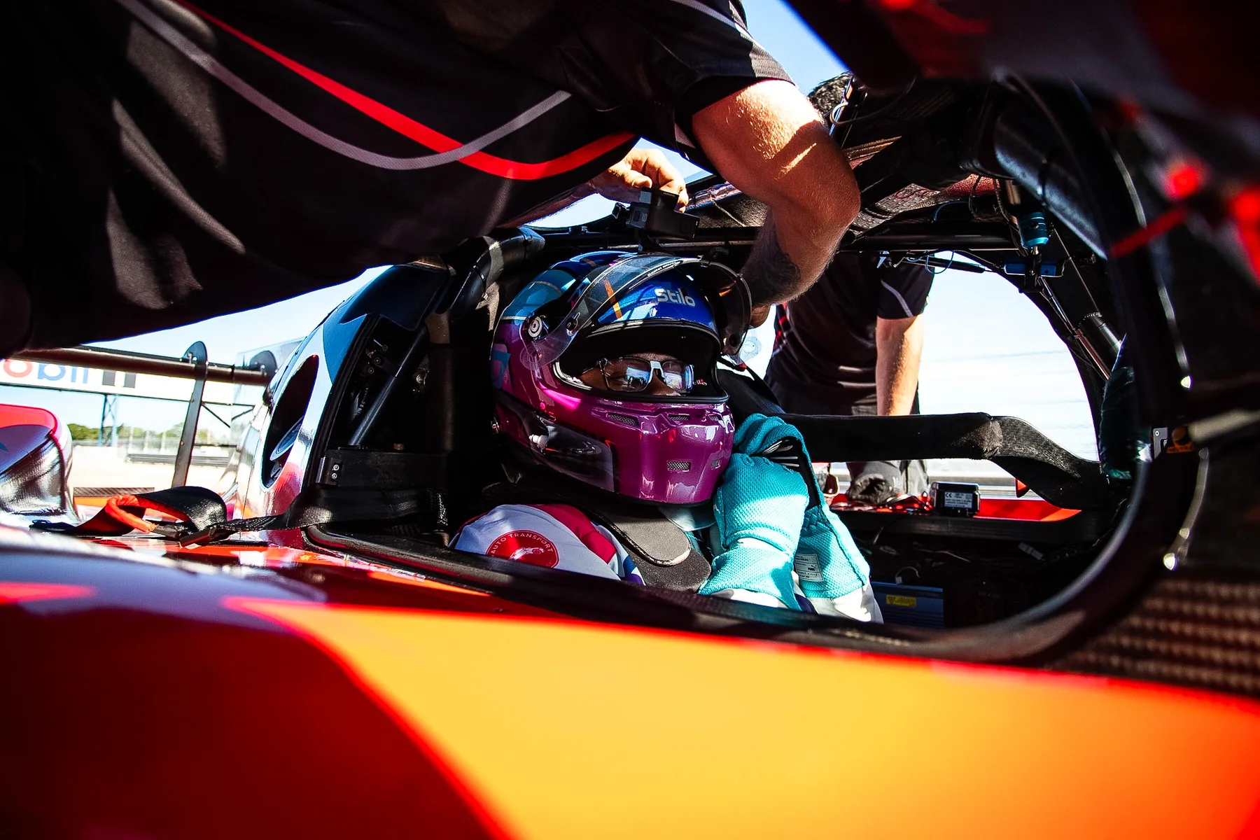 Crew strapping Daniel Oliver into the IMSA LMP3 prototype