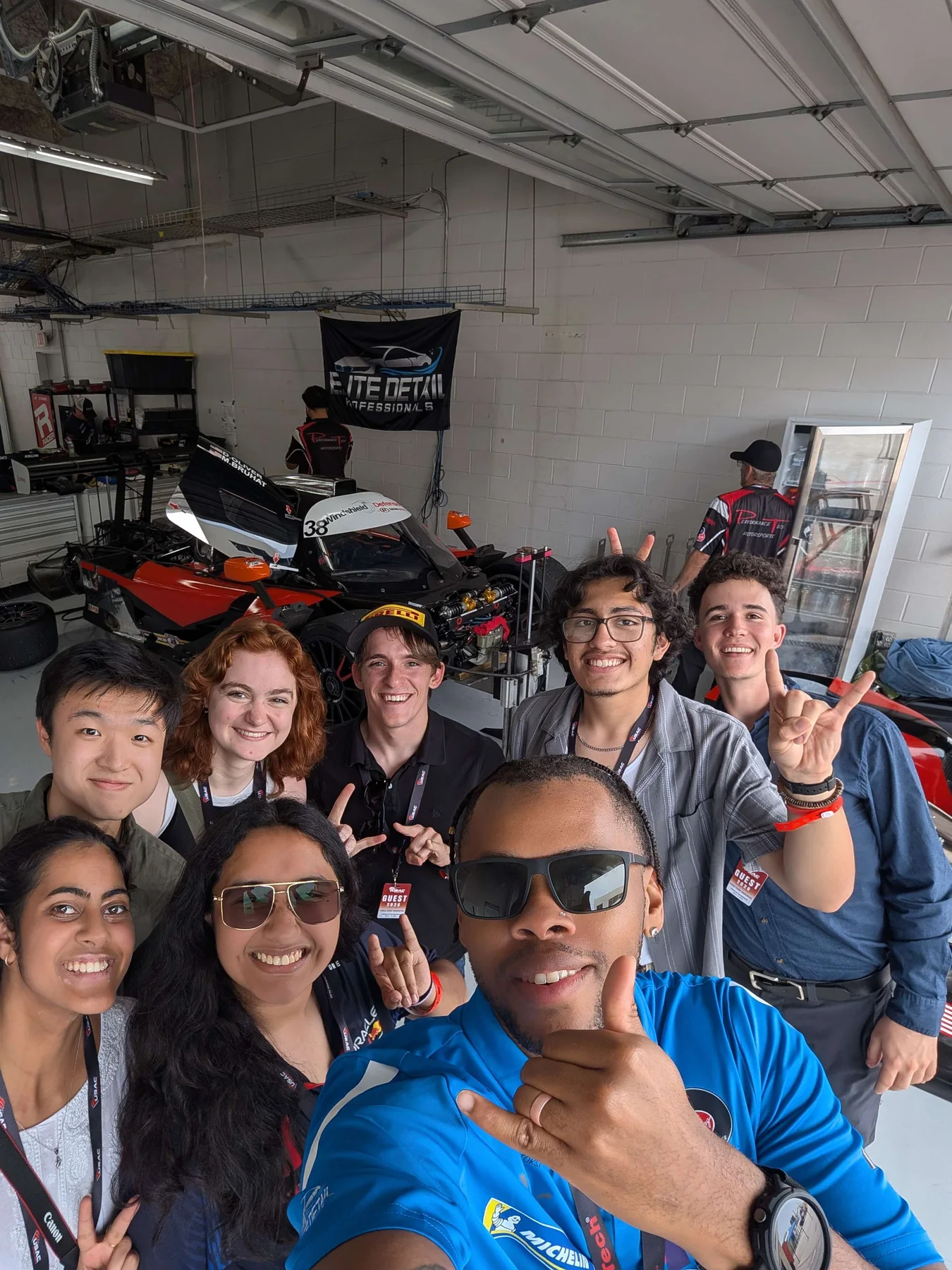 Daniel Oliver with a group of Project Limit Break students in the race garage